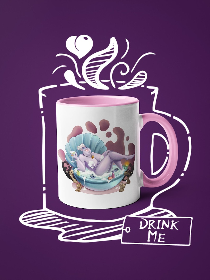 May include: White ceramic mug with a pink interior and handle. The mug features a cartoon illustration of a purple character in a seashell bathtub. The words "DRINK ME" are on a tag attached to the mug.