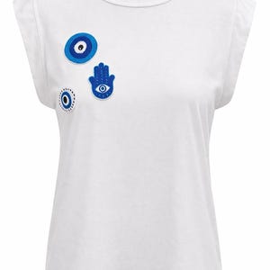 Camiseta blanca con ojo turco, top con bordado a mano de Hamsa, camiseta con símbolos de protección de Oriente Medio, camiseta boho minimalista, camiseta con parche hecho a mano.