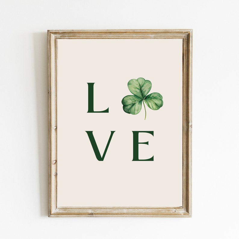 May include: A framed print with a green shamrock and the word "LOVE" in green text.