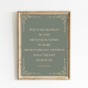 May include: A framed print with a green background and gold lettering. The text reads "May your troubles be less and your blessings be more and nothing but happiness walk through your door. Irish Blessing."