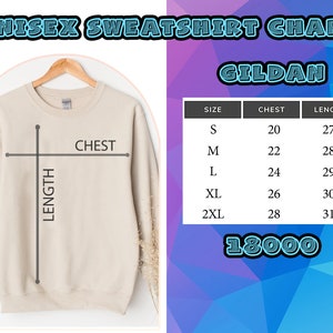 May include: A beige crewneck sweatshirt on a wooden hanger with a size chart titled UNISEX SWEATSHIRT CHART GILDAN 18000. The chart lists sizes S through 2XL with chest and length measurements in inches, ranging from 20 to 28 and 27 to 31 respectively.