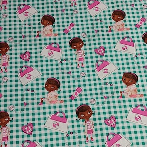 May include: Fabric with a repeating pattern of a cartoon doctor, medical bags, stethoscopes, hearts, and bandages on a green and white checkered background. The doctor is wearing a pink and white outfit and has a stethoscope around her neck.