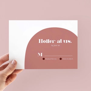 May include: A white card with the text "Holler at us." in a modern font, with a large, semi-circular, dusty rose shape. The card also includes the text "by June 1st" and two small circles with text below them.