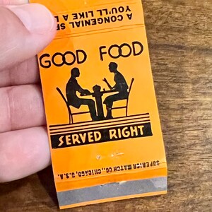 May include: Orange matchbook with black text and a silhouette of two people sitting at a table. The text reads "Good Food Served Right".