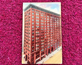 May include: A vintage postcard featuring a black and white photo of the Monadnock Building in Chicago. The text on the postcard reads "Monadnock Building, Dearborn. Jackson and Van Buren St., Chicago. The largest office building in Chicago."