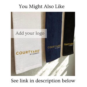May include: Three hotel towels in white, navy blue, and black, each with the "COURTYARD BY MARRIOTT" logo embroidered in gold. The image includes the text "You Might Also Like", "Add your logo", and "See link in description below".
