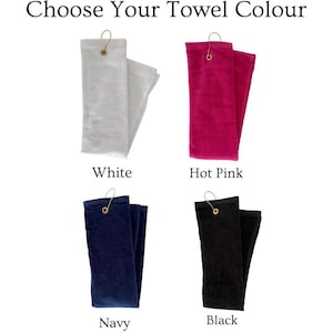 May include: Image shows four folded towels in white, hot pink, navy, and black. Each towel has a gold-colored metal hook. The text at the top says "Choose Your Towel Colour".