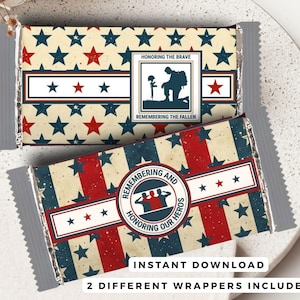 May include: Two chocolate bar wrappers with patriotic designs. One features a soldier silhouette and the text "Honoring the Brave, Remembering the Fallen." The other wrapper says "Remembering and Honoring Our Heroes." Both have red, white, and blue star patterns.