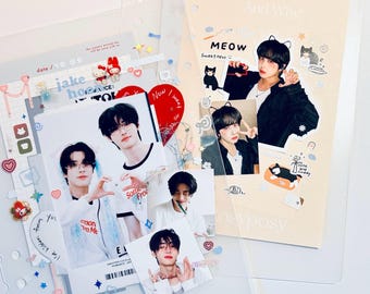 May include: A collection of clear plastic sleeves and photo cards. The photo cards feature images of a person, along with decorative stickers and text. One page has the text "MEOW Sweetness" and "And Why". The theme appears to be related to K-pop.