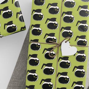 May include: Several wrapped gifts with a repeating pattern of black coffee makers with cat faces on a light green background. The gifts are tied with twine and have white paper tags. A ball of twine and scissors are also visible.