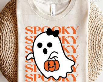 May include: A cream-coloured t-shirt with a Halloween design. It features a white ghost with a black bow and a jack-o'-lantern. The word "SPOOKY" is printed in orange vertically behind the ghost.