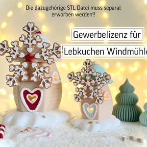 May include: Two gingerbread house figurines with snowflake toppers and heart-shaped accents sit on a snowy surface. The text "Gewerbelizenz für Lebkuchen Windmühle" is displayed. Additional decorative elements include candy canes and small Christmas trees.