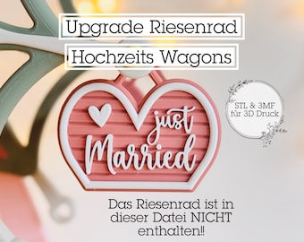 May include: A pink and white heart-shaped wedding decoration with the words "just Married" in cursive. A small white heart is on the left side. The text "Upgrade Riesenrad Hochzeits Wagons" is at the top.