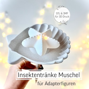 May include: A white, 3D-printed seashell-shaped insect waterer with a star-shaped element in the center. The text "Insektentränke Muschel für Adapterfiguren" is displayed below the object. The image also includes the text "STL & 3MF für 3D Druck".