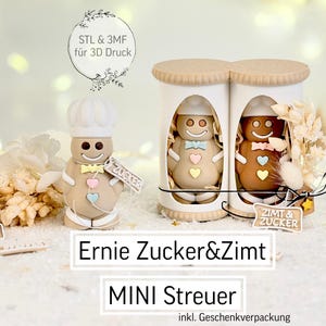 May include: Gingerbread-themed decorations are displayed. One gingerbread man wears a chef's hat and holds a sign that says "Zucker". Two gingerbread men are inside a container. The text "Ernie Zucker&Zimt" and "MINI Streuer" are also visible.