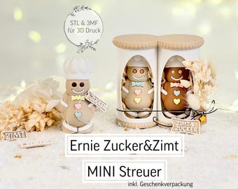 May include: A display of gingerbread-themed decorations. One gingerbread man wears a chef's hat and holds a sign that says "Zucker". Two gingerbread men are inside a container. The text "Ernie Zucker&Zimt" and "MINI Streuer" are also visible.