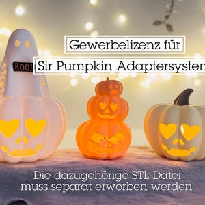 May include: Three Halloween-themed decorative lights. A ghost-shaped light with "BOO!" text, a stacked pumpkin light, and a pumpkin light with heart-shaped eyes. The text "Sir Pumpkin Adaptersystem" is visible.