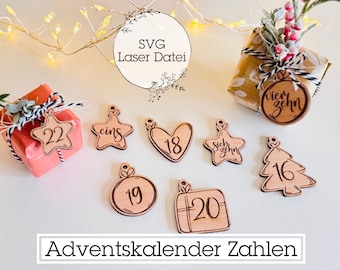 May include: Wooden Advent calendar numbers in various shapes, including stars, hearts, and gift boxes. Each number is etched in a dark brown color. The image also includes wrapped gifts and the text "Adventskalender Zahlen".