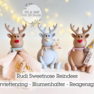 May include: Three reindeer figurines in brown, grey, and blue, each with antlers and a red nose. One holds a napkin, another flowers, and the third a test tube. Text reads "Rudi Sweetnose Reindeer".