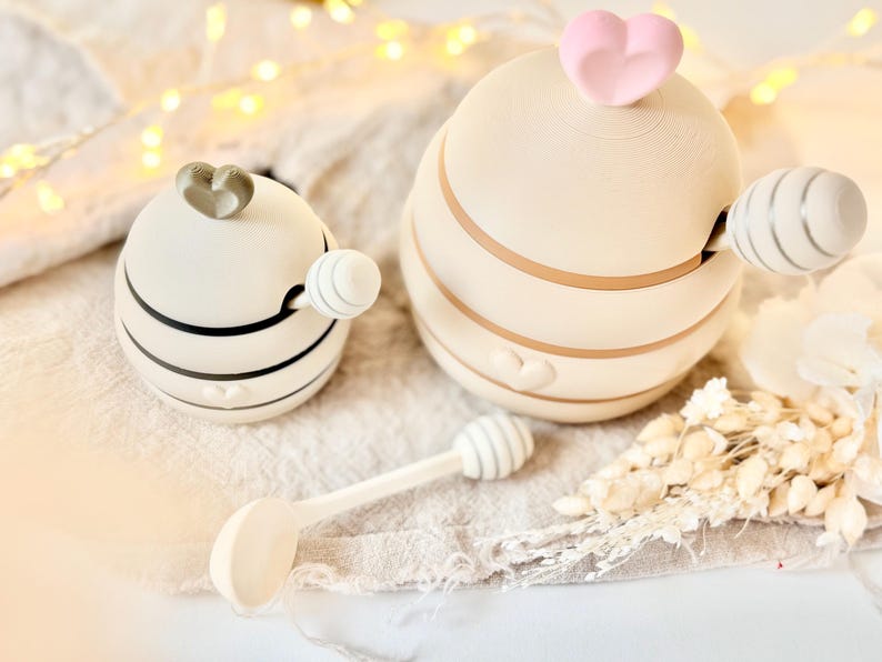 May include: A set of three ceramic mugs with a speckled, matte finish. The mugs are in shades of cream, light gray, and dark gray. Each mug has a simple, minimalist design, perfect for coffee or tea.