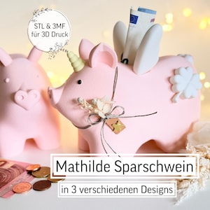 Può includere: Due salvadanai rosa a forma di maiale, uno con corno di unicorno e ali, l'altro semplice. Il maiale unicorno contiene banconote. Il testo "Mathilde Sparschwein in 3 verschiedenen Designs" è sotto. Monete e una banconota da 10 euro sono davanti.