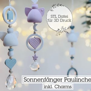 May include: Three white and light blue hanging ornaments with a crystal prism at the bottom. The ornaments feature a heart, a star, and an angel. The text "STL Datei für 3D Druck" is visible in the image. The text "Sonnenfänger Paulinchen inkl. Charms" is also visible in the image.