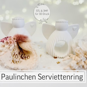 May include: Two white angel napkin rings with heart-shaped wings and a decorative floral arrangement. The napkin rings are 3D printed. The text "Paulinchen Serviettenring" is displayed at the bottom of the image.
