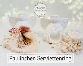 May include: Two white angel napkin rings with heart-shaped wings and a decorative floral arrangement. The napkin rings are 3D printed. The text "Paulinchen Serviettenring" is displayed at the bottom of the image.