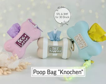 May include: Three bone-shaped dog poop bag holders in pink, beige, and blue. The pink holder has "Dog Lover" text, the beige one says "Shit happens", and the blue one says "mach rein Scheiß". Each holds a roll of bags.