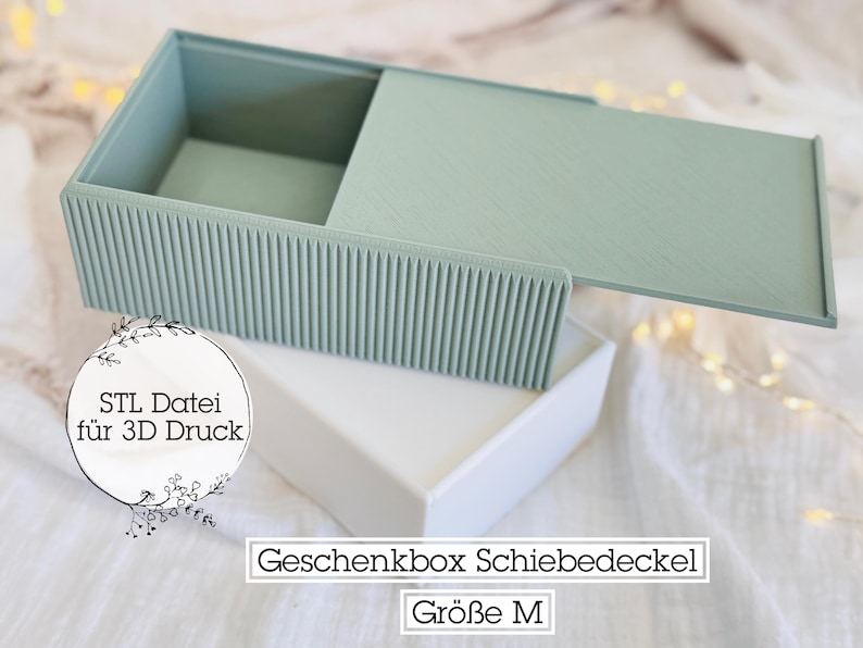 May include: A light green sliding lid box with a textured, ribbed front. The box is open, revealing the interior. The box sits on a white box. Text on the image reads "STL File for 3D Print" and "Gift Box Sliding Lid Size M".