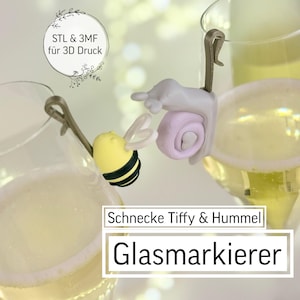 Könnte beinhalten: Zwei Champagnergläser gefüllt mit einem sprudelnden Getränk, jedes mit einem skurrilen Glasmarker verziert. Ein Marker ist eine gelb-schwarze Biene, der andere eine hellviolette Schnecke. Der Text im Bild lautet "STL & 3MF für 3D Druck".