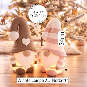 May include: Two gnome-shaped lamps, one brown and one pink, each 34 cm tall. The brown gnome features a white heart on its hat. Both have white beards, striped sleeves, and glowing bases. Text on the image reads STL & 3MF für 3D Druck and WichtelLampe XL Norbert.