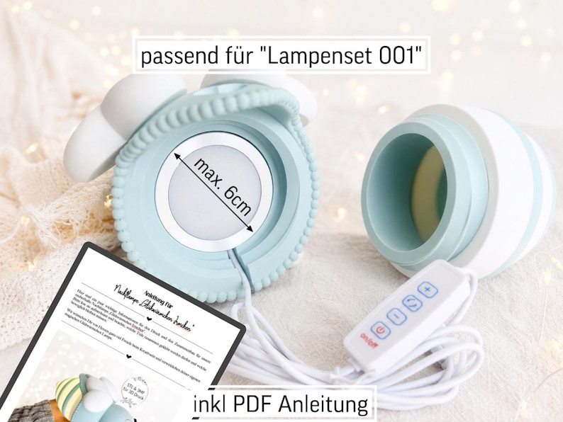 May include: A light blue and white lamp component with a textured edge and a circular light insert measuring max. 6cm. The set includes a white power cord with a four-button controller and a printed instruction sheet labelled passend f&uuml;r Lampenset 001.