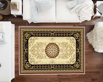 May include: A cream-colored rug with a black, gold, and red intricate design. The rug has a large circular pattern in the center with a smaller circular pattern inside. The rug is surrounded by a black border with gold and red accents.