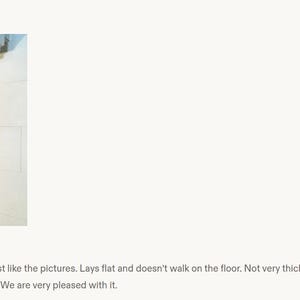 May include: A rectangular runner rug featuring a dense, multi-colored geometric pattern with vibrant shades of red, orange, blue, and black. The rug has a low profile, measuring approximately 0.25 inches in height, and lies flat on the floor.