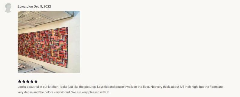 May include: A rectangular runner rug featuring a dense, multi-colored geometric pattern with vibrant shades of red, orange, blue, and black. The rug has a low profile, measuring approximately 0.25 inches in height, and lies flat on the floor.