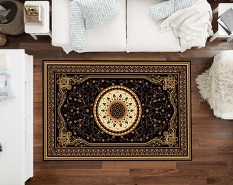 May include: A black and gold patterned rug with a large circular design in the center. The rug has a detailed border with intricate floral motifs.