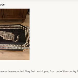 May include: A rectangular rug featuring a black centre with a realistic leopard illustration. The rug is bordered by a white and black chain-link pattern and a gold-coloured outer edge, creating a distinct frame around the central animal motif.