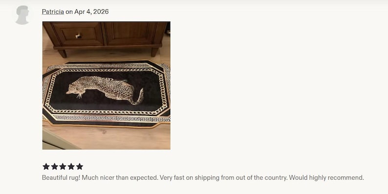 May include: A rectangular rug featuring a black centre with a realistic leopard illustration. The rug is bordered by a white and black chain-link pattern and a gold-coloured outer edge, creating a distinct frame around the central animal motif.