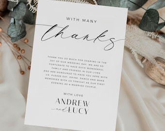 May include: A simple, elegant thank you card with black calligraphy that reads "With Many Thanks". The card has a white background and black text that says "Thank you so much for sharing in the joy of our wedding day. We are so fortunate to have such wonderful family and friends in our lives and are honoured to have you here with us. Please eat, drink, dance and make memories with us tonight as our first evening as a married couple... With love, Andrew and Lucy."