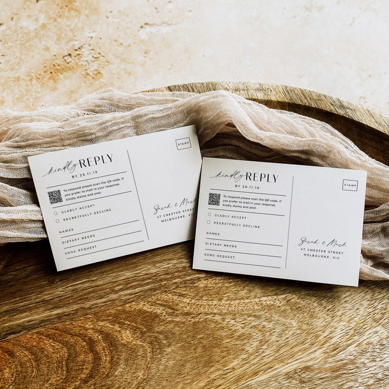 May include: Two white RSVP cards with a black and white QR code, the text "kindly reply" and the text "By 28.11.19". The cards have a section for guests to indicate whether they will be attending the event, and a section for guests to provide their names, dietary needs, and song requests.