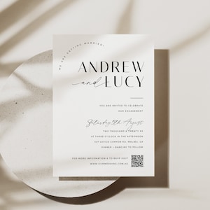 May include: A white wedding invitation card with black text announcing the engagement of Andrew and Lucy. The invitation includes the date, time, and location of the event, as well as a QR code for RSVP.