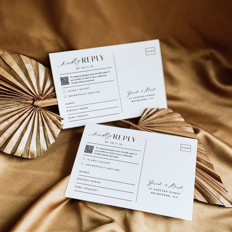 May include: Two white RSVP cards with a black and white design. The cards have a QR code, a section for names, dietary needs, and song requests. The text on the cards reads "kindly REPLY" and includes the date "BY 28.11.19". The cards also have the address "Jared & Mark, 47 Chester Street, Melbourne, VIC".