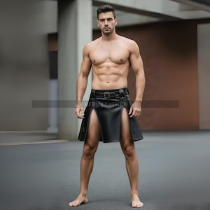 May include: A black leather kilt with a belt and buckle. The kilt has a split front design. The model is standing in a modern setting.