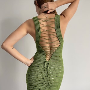 May include: A green crochet mini dress with a lace-up back.