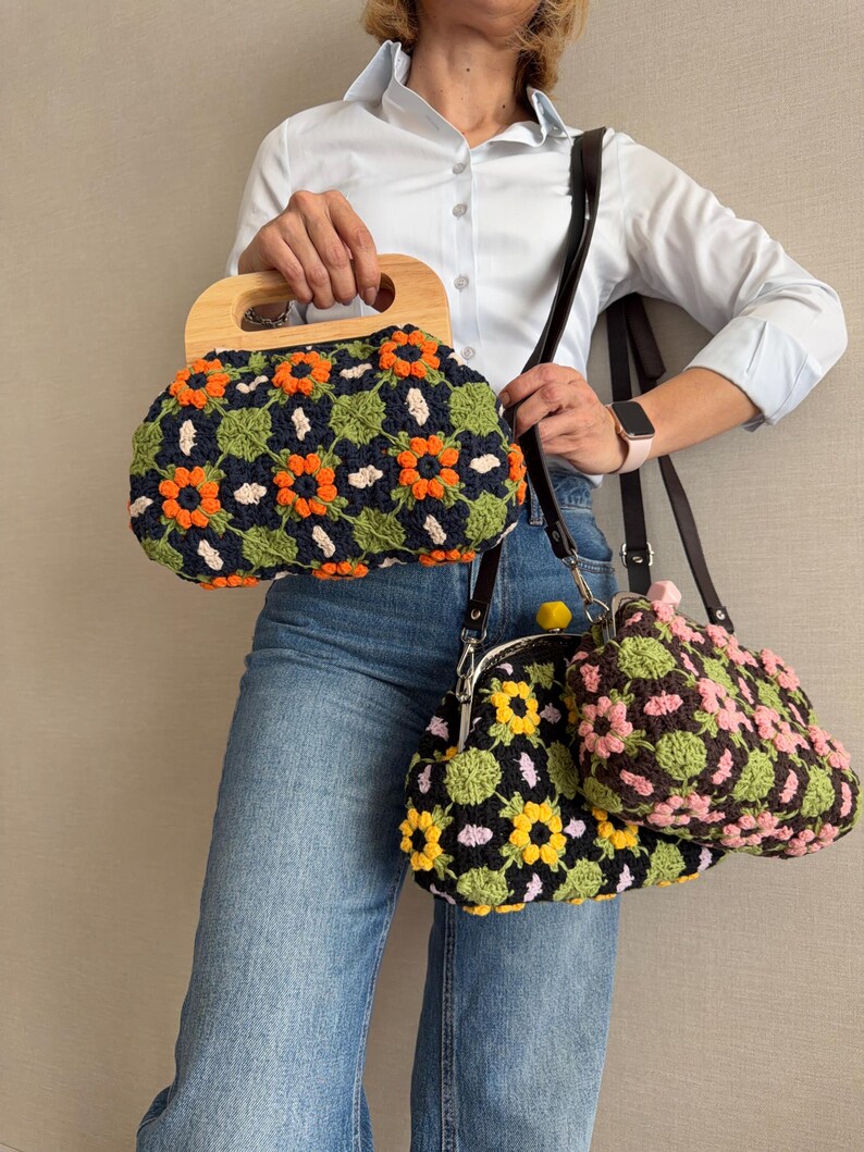 Puede incluir: Tres bolsos de crochet con estampados florales. El bolso m&aacute;s grande tiene un asa de madera y un fondo azul marino con flores naranjas y verdes. Los otros dos bolsos tienen fondos negros con dise&ntilde;os florales amarillos, rosas y verdes. Todos los bolsos tienen correas marrones oscuras.