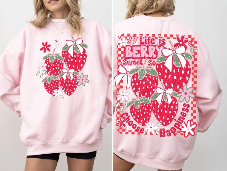 May include: Pink sweatshirt with a graphic of strawberries and the text "Life is Berry Sweet So Choose Happiness" on the back.