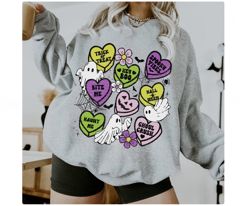 May include: Gray sweatshirt with a Halloween-themed design featuring candy hearts with phrases like "Trick or Treat", "Bite Me", and "Ghoul Crush".