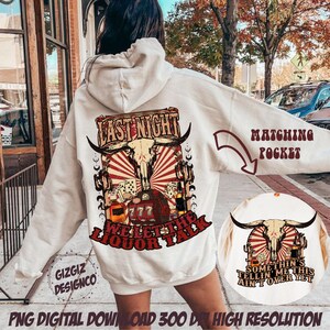 May include: A white hoodie with a red and white graphic print of a skull with horns and the text "Last Night We Let The Liquor Talk". The hoodie has a matching pocket on the front with the text "Somethin's Tellin' Me This Ain't Over Yet".