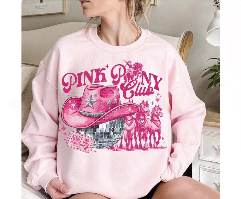 May include: A light pink sweatshirt with a graphic design featuring a pink cowboy hat, a disco ball, and the words "PINK PONY CLUB". The design also includes illustrations of horses and a ticket that says "ADMIT ONE".